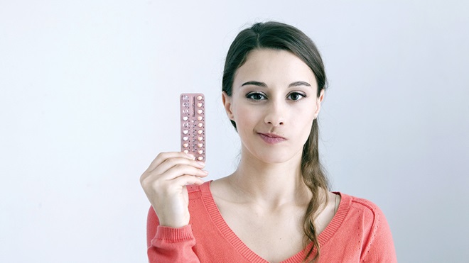 woman holding pill packet